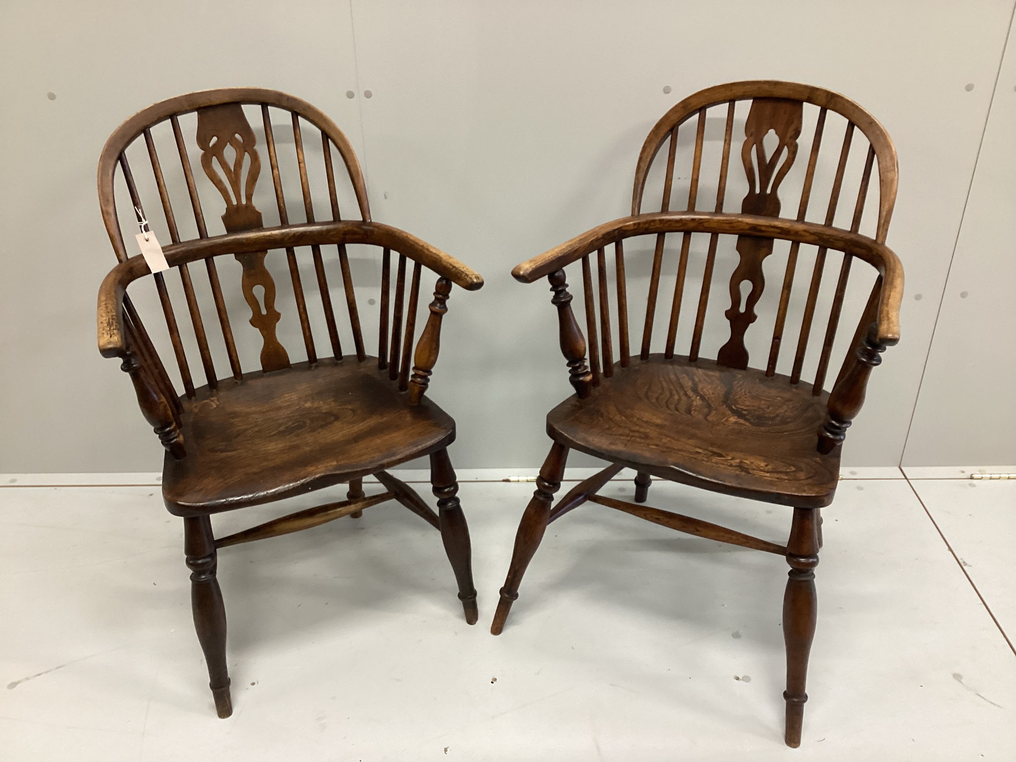 A near pair of 19th century ash and elm Windsor elbow chairs, width 59cm, depth 37cm, height 94cm